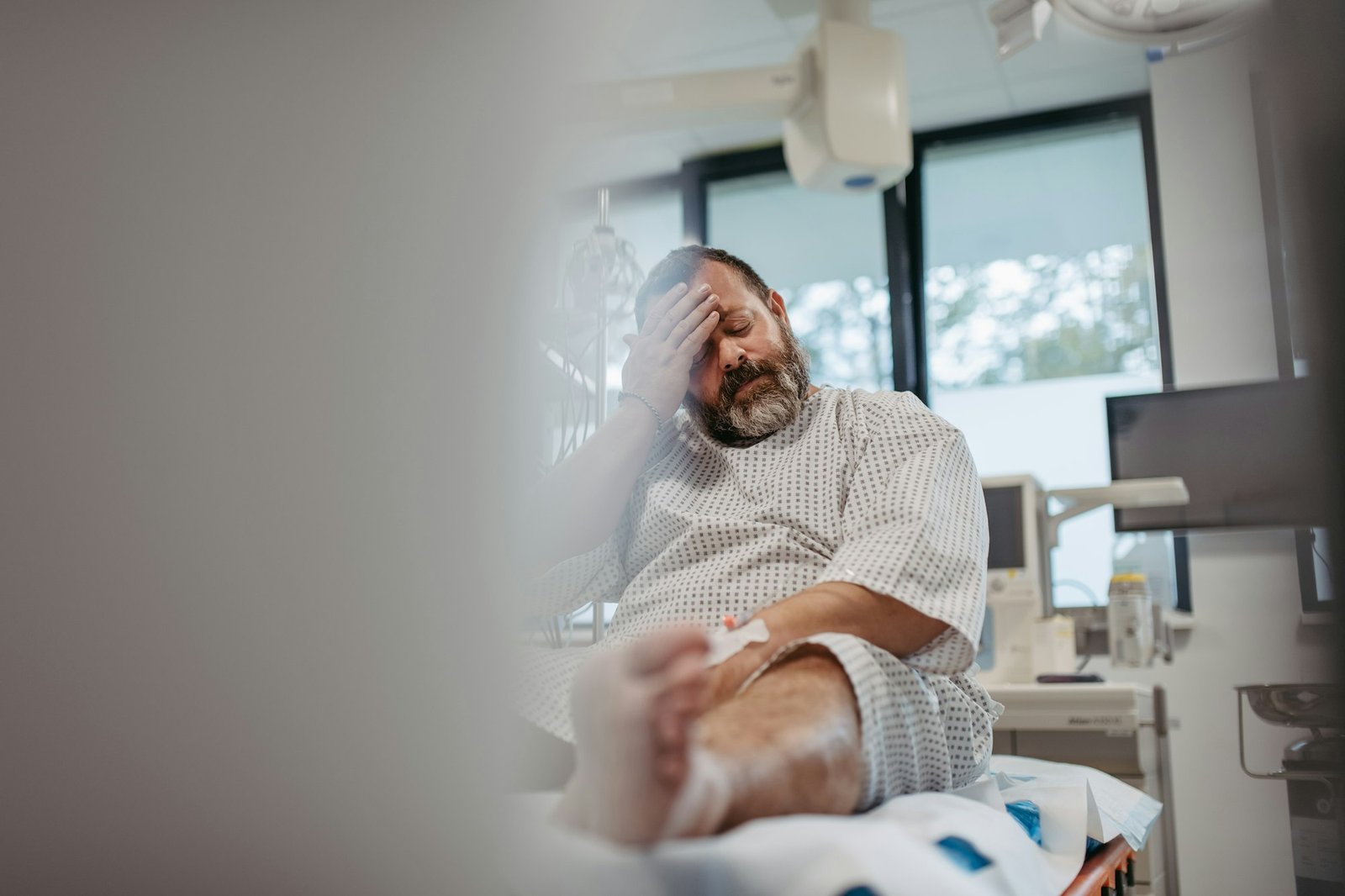 Overweight patient in hospital gown waiting for medical examination, test results in hospital