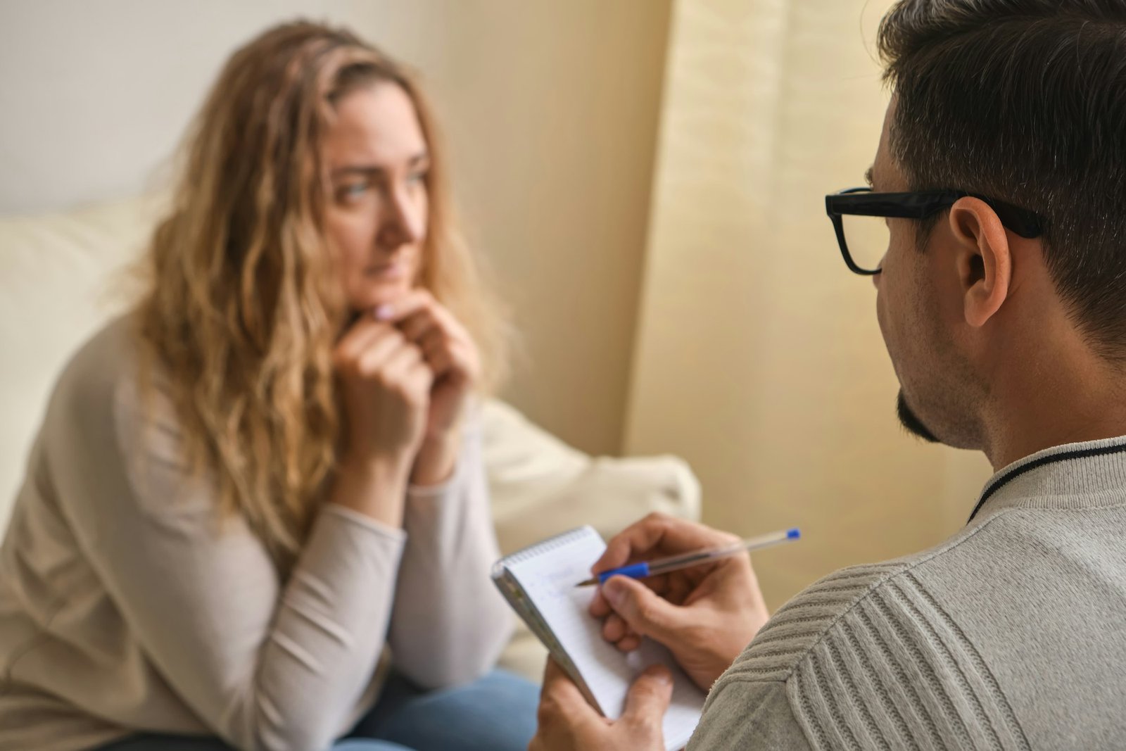 Serious Caucasian male doctor talk discuss results or symptoms with female patient.